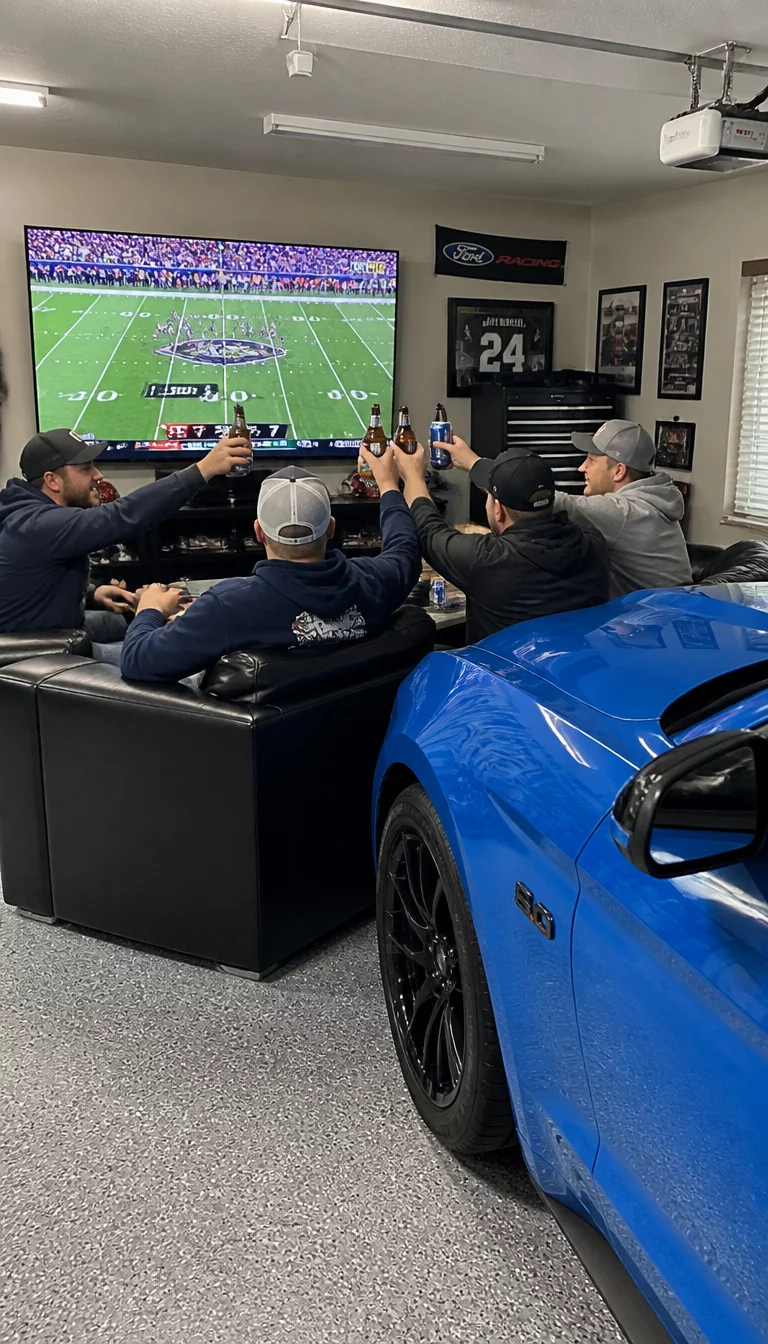 A realistic photo of a garage lounge featuring a group of friends celebrating in front of a large flat screen television showing a football game, with a shiny blue sports car parked nearby and cold drinks held high in a toast, bright overhead lighting.