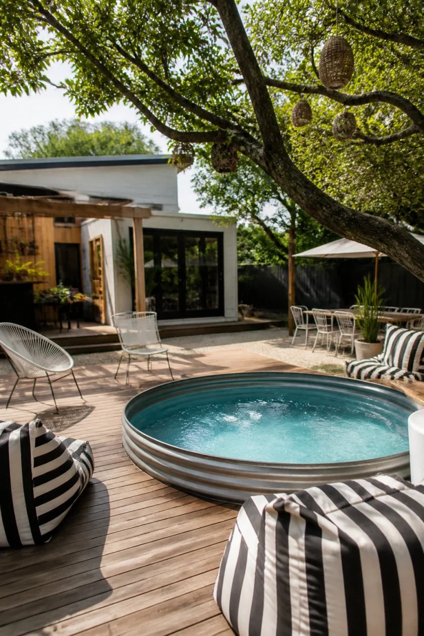 Circle Of Friends Gathering A realistic photo of a stylish backyard with a circular stock tank pool built into a deck, surrounded by modern chairs and black and white striped bean bags under a tree.